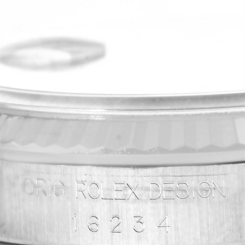 The image shows a close-up of the casing of a Rolex Datejust 16234 Men's Stainless Steel Silver Dial 16234 Men's Stainless Steel Silver Dial watch, highlighting the engraved model number 16234.