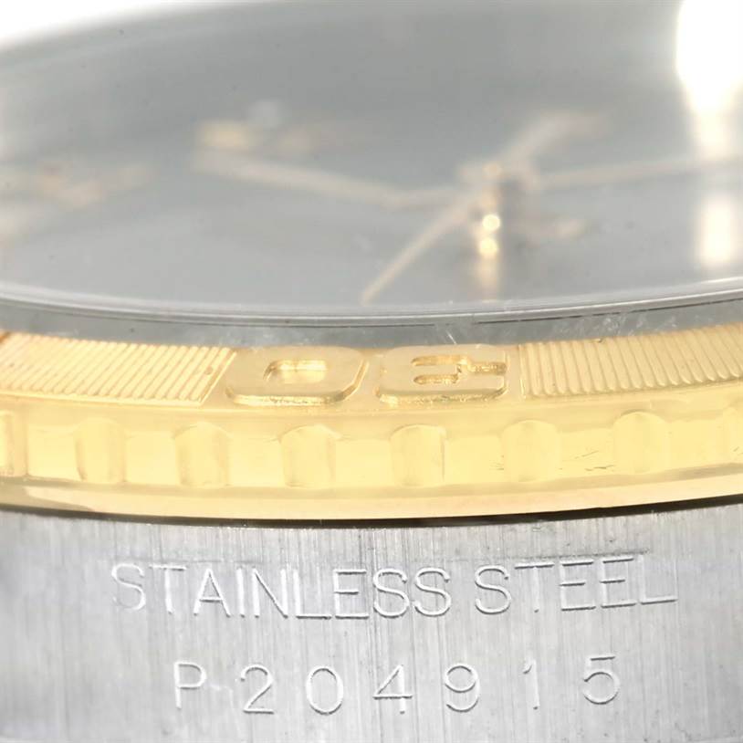 This close-up shows the bezel and engraved serial number on a Rolex Datejust 16263 Men's Steel and Gold (two tone) Grey Dial 16263 Men's Steel and Gold (two tone) Grey Dial watch.