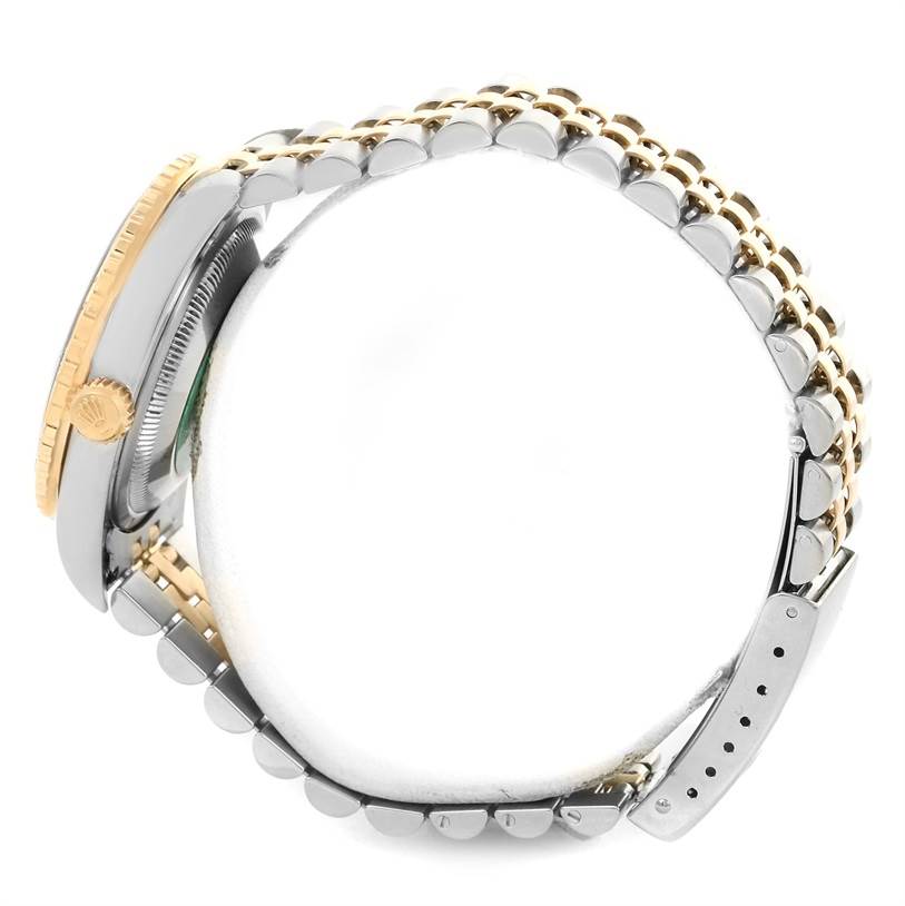 The image shows a side view of the Rolex Datejust 16263 Men's Steel and Gold (two tone) Grey Dial 16263 Men's Steel and Gold (two tone) Grey Dial watch, highlighting its bezel, crown, and two-tone bracelet.