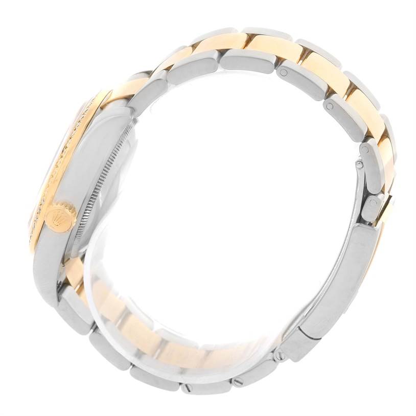 This side view of the Rolex Datejust 116243 Stainless Steel White Dial 116243 Stainless Steel White Dial shows the crown, case, and two-tone bracelet.