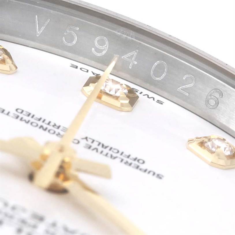 This close-up image shows part of the dial, diamonds, and serial number of a Rolex Datejust 116243 Stainless Steel White Dial 116243 Stainless Steel White Dial watch.