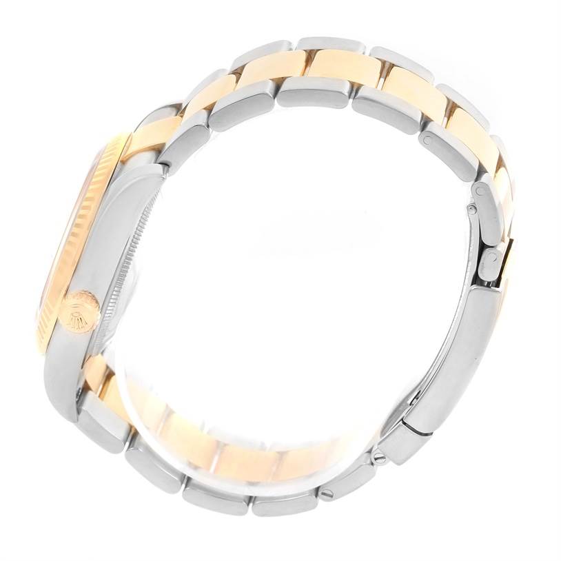 The image shows a side view of a Rolex Datejust 116233 Men
s Stainless Steel Black Dial 116233 Men
s Stainless Steel Black Dial watch showcasing its two-tone bracelet and fluted bezel.