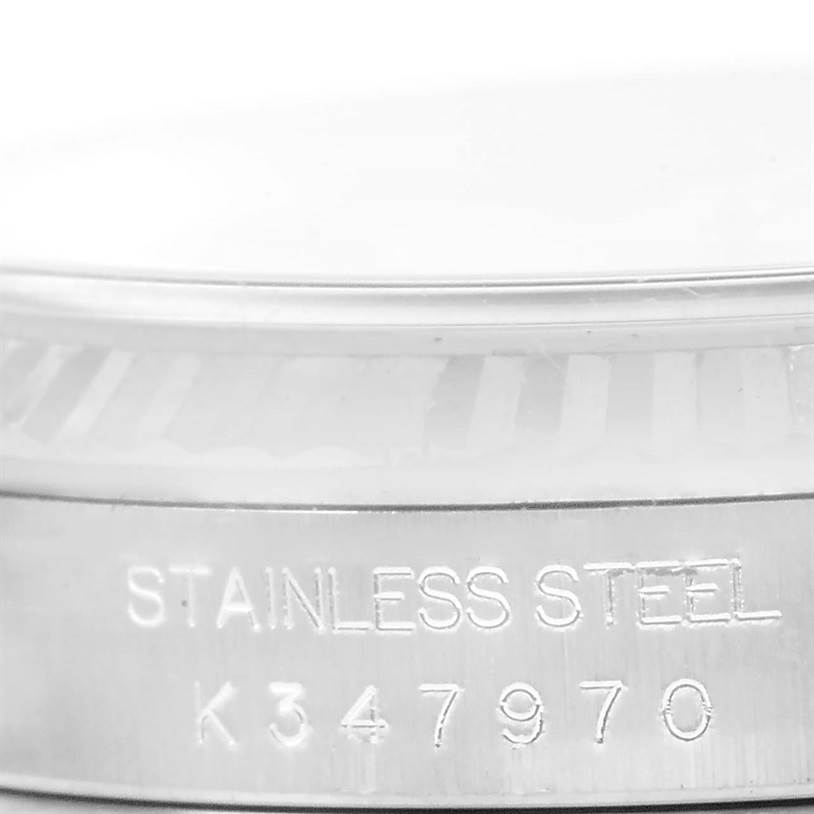 This close-up image of a Rolex Datejust 16234 Men
s Stainless Steel Silver Dial 16234 Men
s Stainless Steel Silver Dial watch shows the stainless steel case with its engraved serial number.