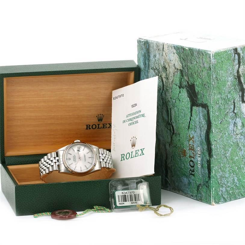 The Rolex Datejust 16234 Men
s Stainless Steel Silver Dial 16234 Men
s Stainless Steel Silver Dial watch is displayed inside its box, which is open, alongside its certificate and packaging.