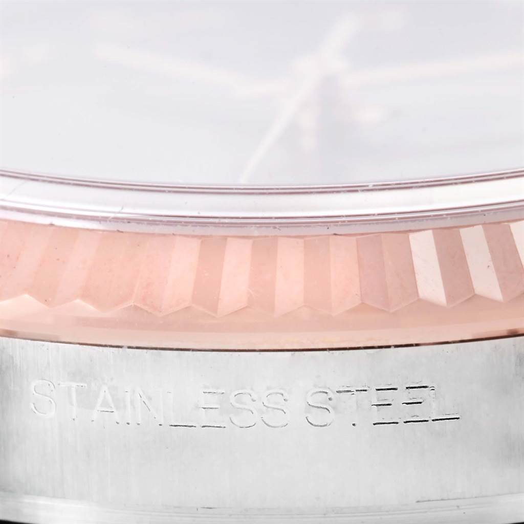 The image shows a close-up of the bezel and part of the casing of a Rolex Datejust 116201 Men
s Steel and Gold (two tone) Grey Dial 116201 Men
s Steel and Gold (two tone) Grey Dial watch, with the word "STAINLESS STEEL" engraved on it.