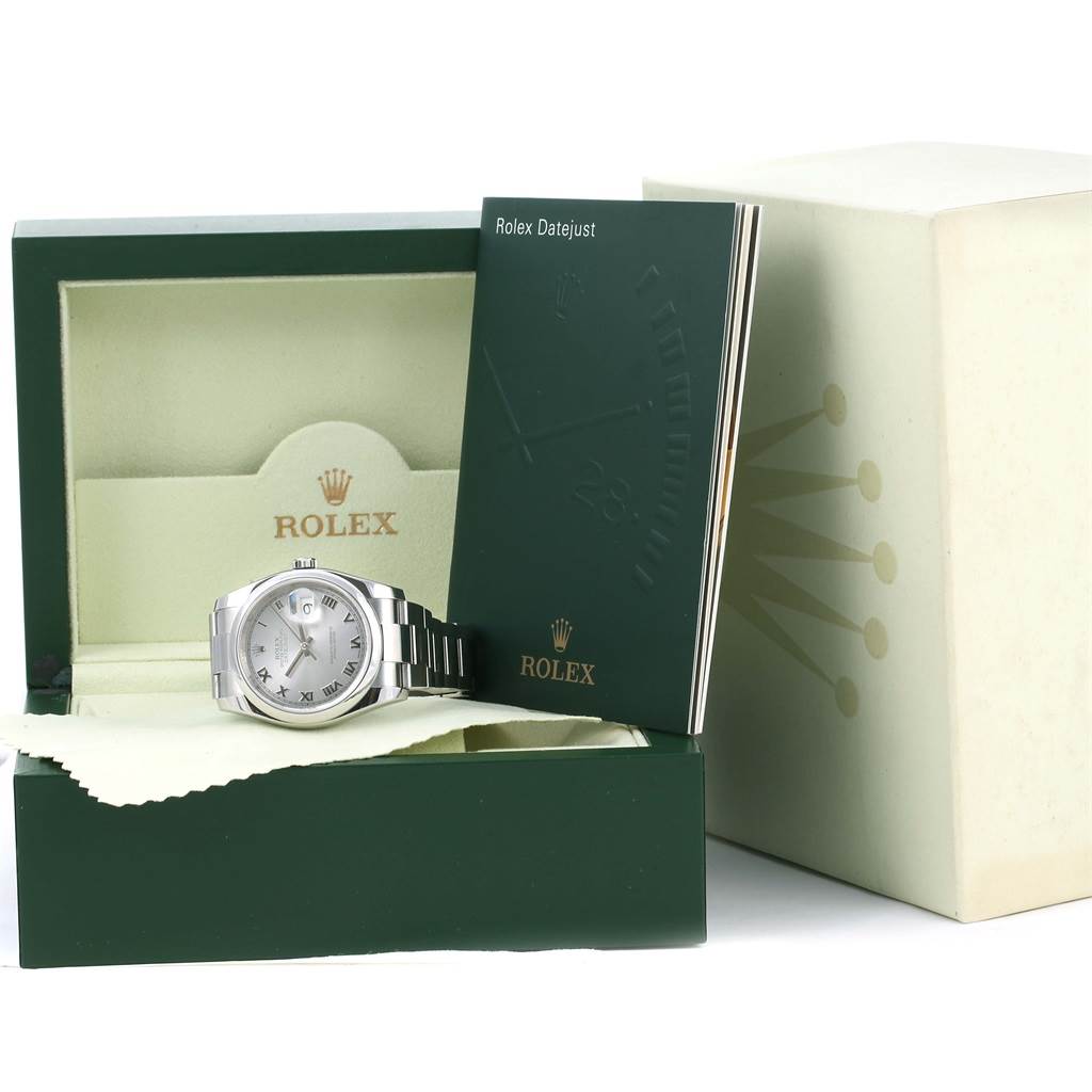 The image shows a Rolex Datejust 116200 Men
s Stainless Steel Silver Dial 116200 Men
s Stainless Steel Silver Dial watch at a slight angle, presented in its open green box, alongside a booklet and warranty card holder.
