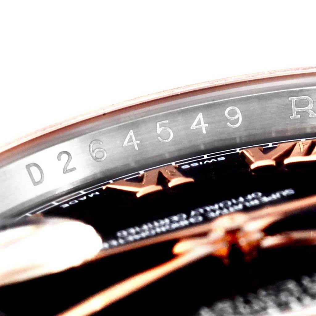 This close-up shows the serial number engraving on the inner bezel and part of the dial of a Rolex Datejust 116231 Men's Steel and Gold (two tone) Black Dial 116231 Men's Steel and Gold (two tone) Black Dial watch.