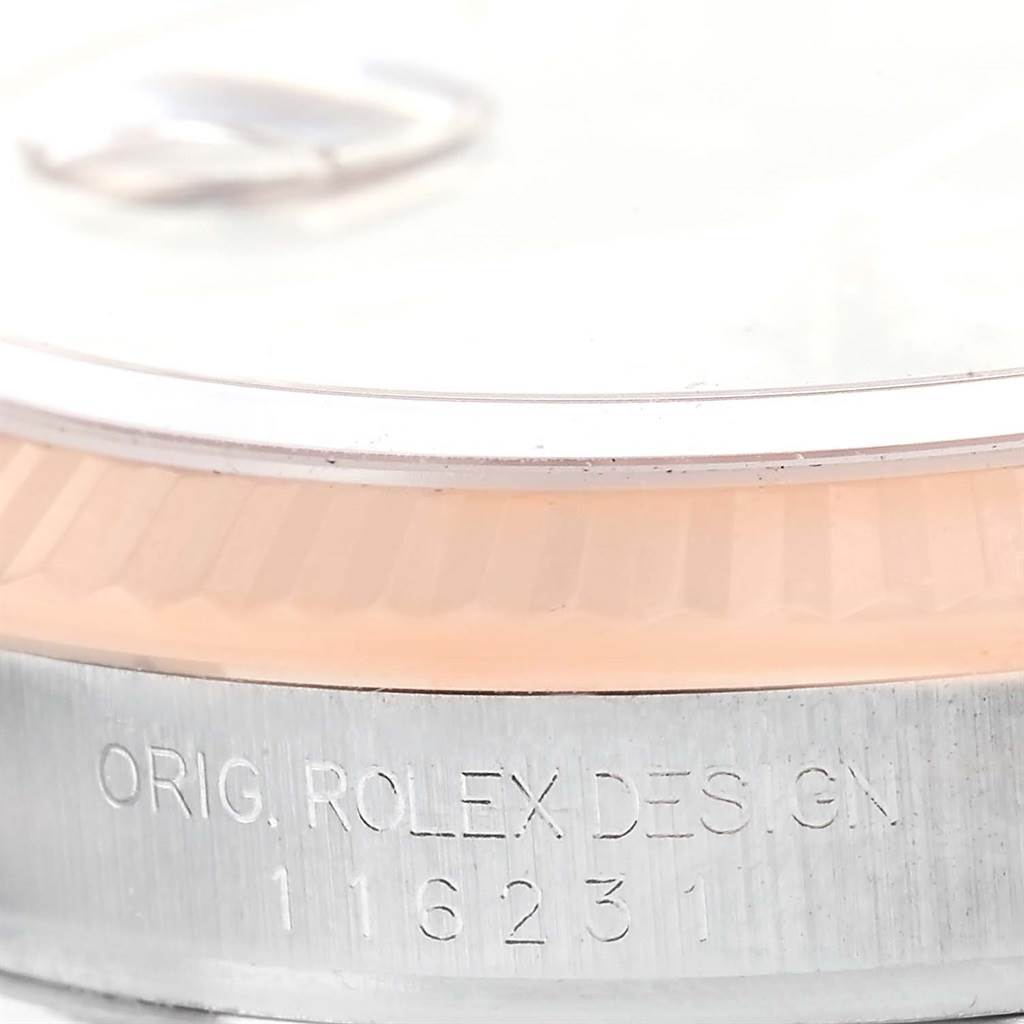 The image shows a close-up of the serial number and part of the bezel on a Rolex Datejust 116231 Men's Steel and Gold (two tone) Black Dial 116231 Men's Steel and Gold (two tone) Black Dial watch.