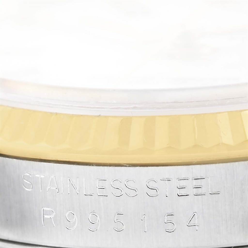 This image shows a close-up of the serial number engraving and the side of the bezel of a Rolex Datejust 16233 Men's Steel and Gold (two tone) White Dial 16233 Men's Steel and Gold (two tone) White Dial watch.