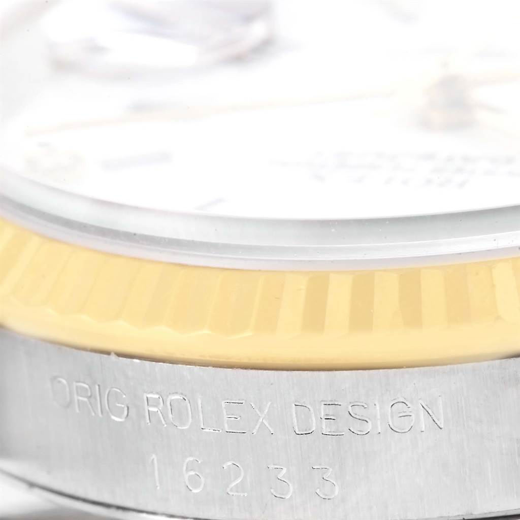 The image shows a close-up angle of the side of a Rolex Datejust 16233 Men's Steel and Gold (two tone) White Dial 16233 Men's Steel and Gold (two tone) White Dial watch, highlighting the bezel and engraved serial number.
