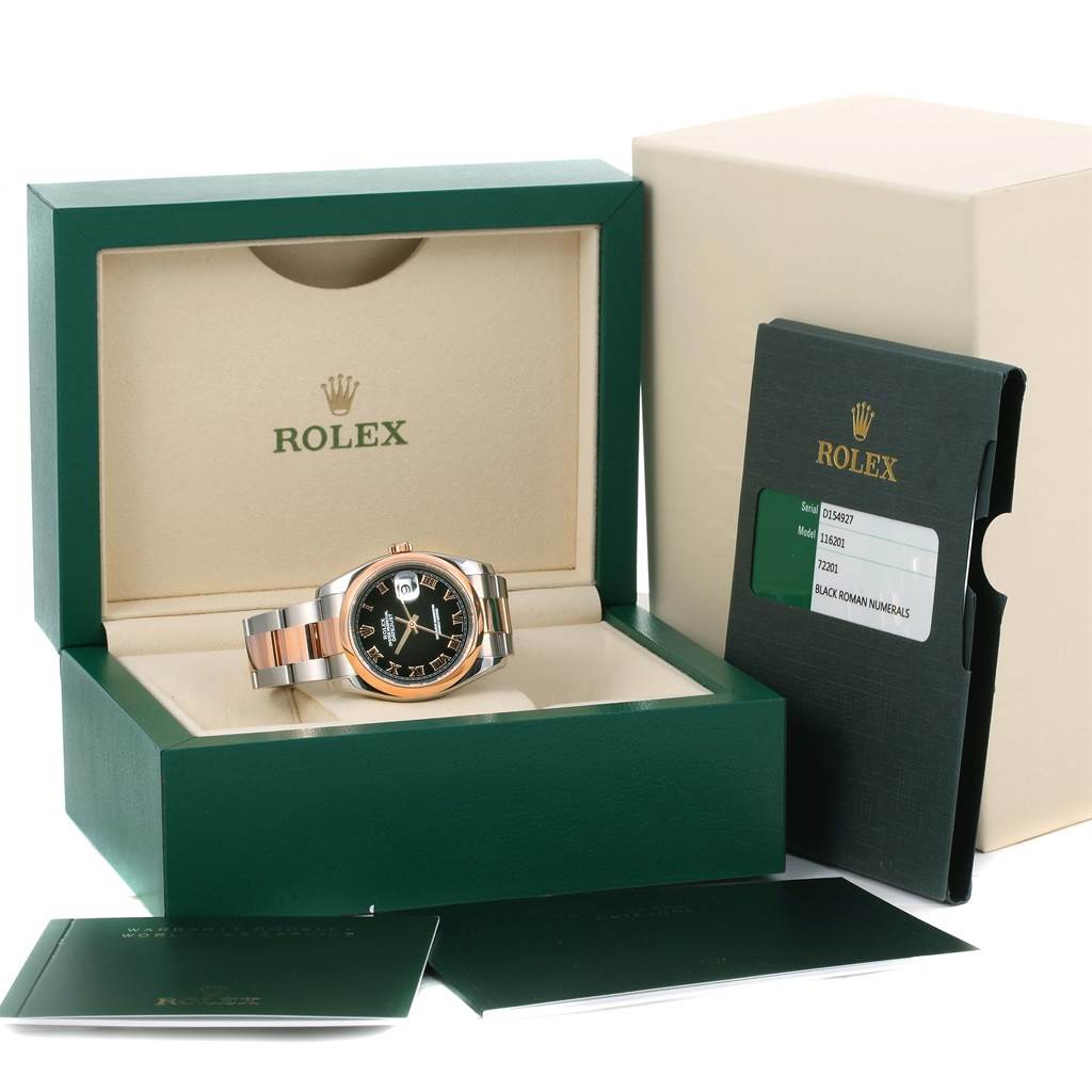 The Rolex Datejust 116201 Steel and Gold (two tone) Black Dial 116201 Steel and Gold (two tone) Black Dial watch is pictured in its open box, alongside booklets and a warranty card.