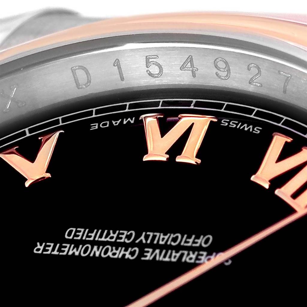 The image shows a close-up of the Rolex Datejust 116201 Steel and Gold (two tone) Black Dial 116201 Steel and Gold (two tone) Black Dial's dial, including the Roman numerals, bezel, and a partial view of the serial number.