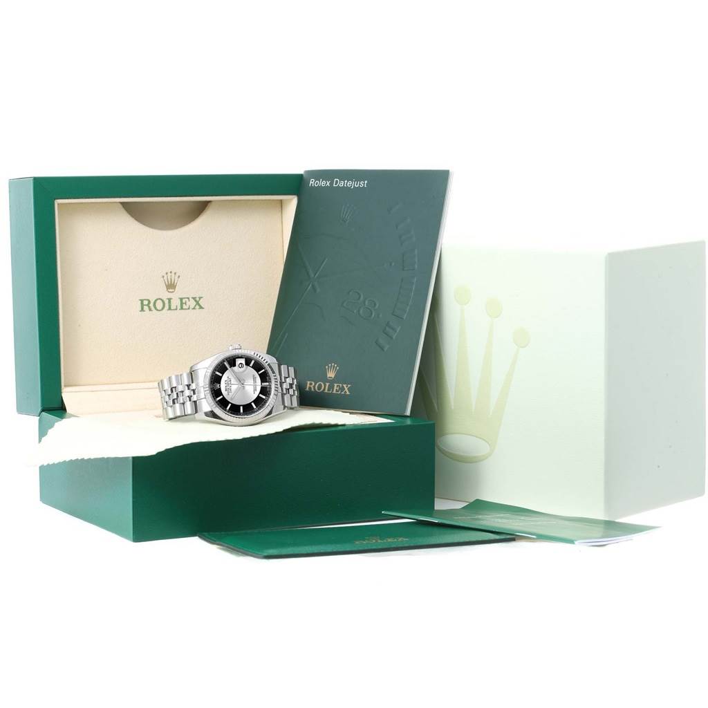 This image shows a Rolex Datejust 116234 Men's Stainless Steel Black Dial 116234 Men's Stainless Steel Black Dial watch placed in an open box with a booklet and small cards displayed.