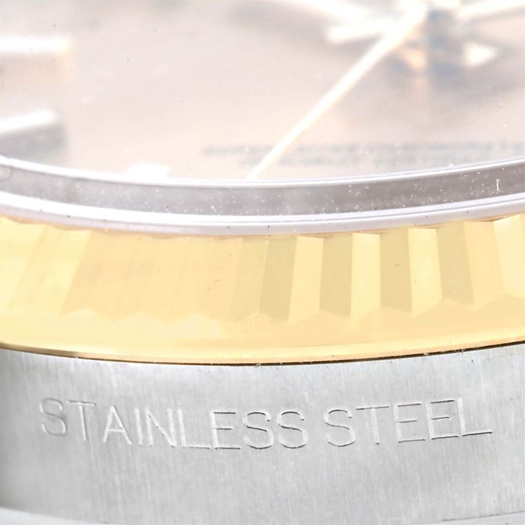 This close-up image shows the fluted bezel and part of the case side with "STAINLESS STEEL" engraving of a Rolex Datejust 116233 Men's Stainless Steel Champagne Dial 116233 Men's Stainless Steel Champagne Dial watch.