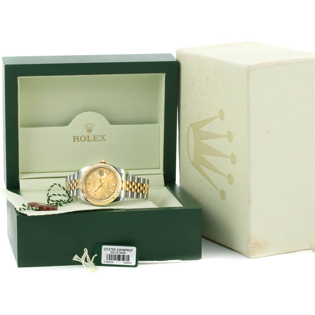 The Rolex Datejust 116233 Men's Stainless Steel Champagne Dial 116233 Men's Stainless Steel Champagne Dial watch is shown in its green box, with accessories including tags and an outer box visible.