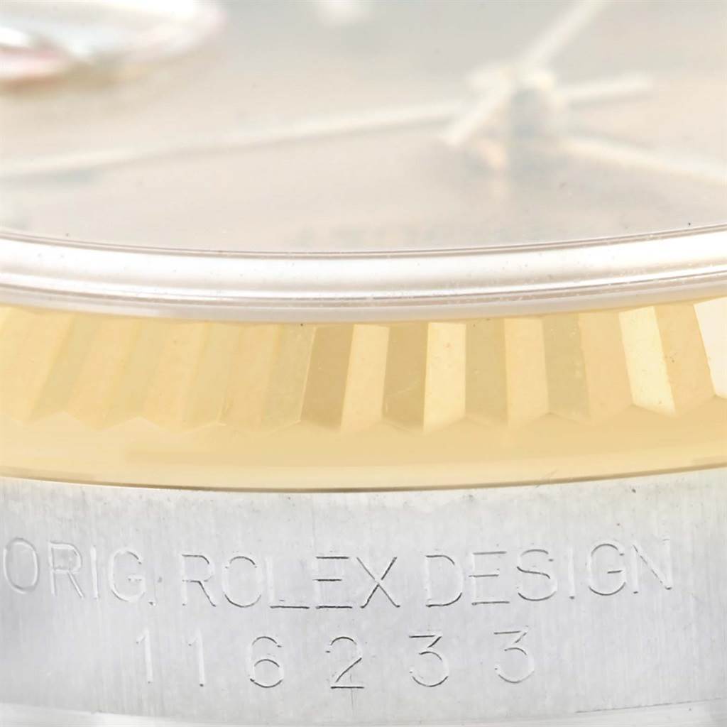 The image shows a close-up of the bezel and engraved serial number of a Rolex Datejust 116233 Men's Stainless Steel Champagne Dial 116233 Men's Stainless Steel Champagne Dial watch.