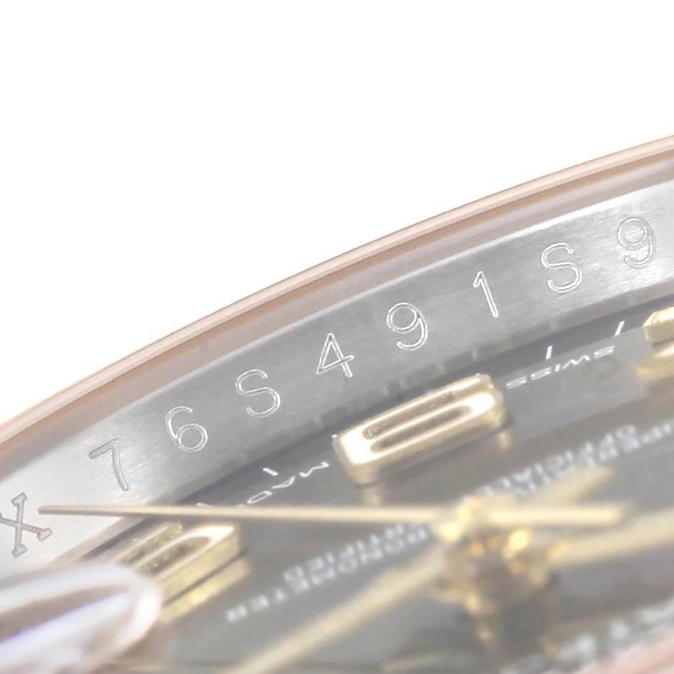 This image shows a close-up view of the engraved serial number on the dial bezel of a Rolex Datejust 116233 Men
s Stainless Steel Brown Dial 116233 Men
s Stainless Steel Brown Dial watch.