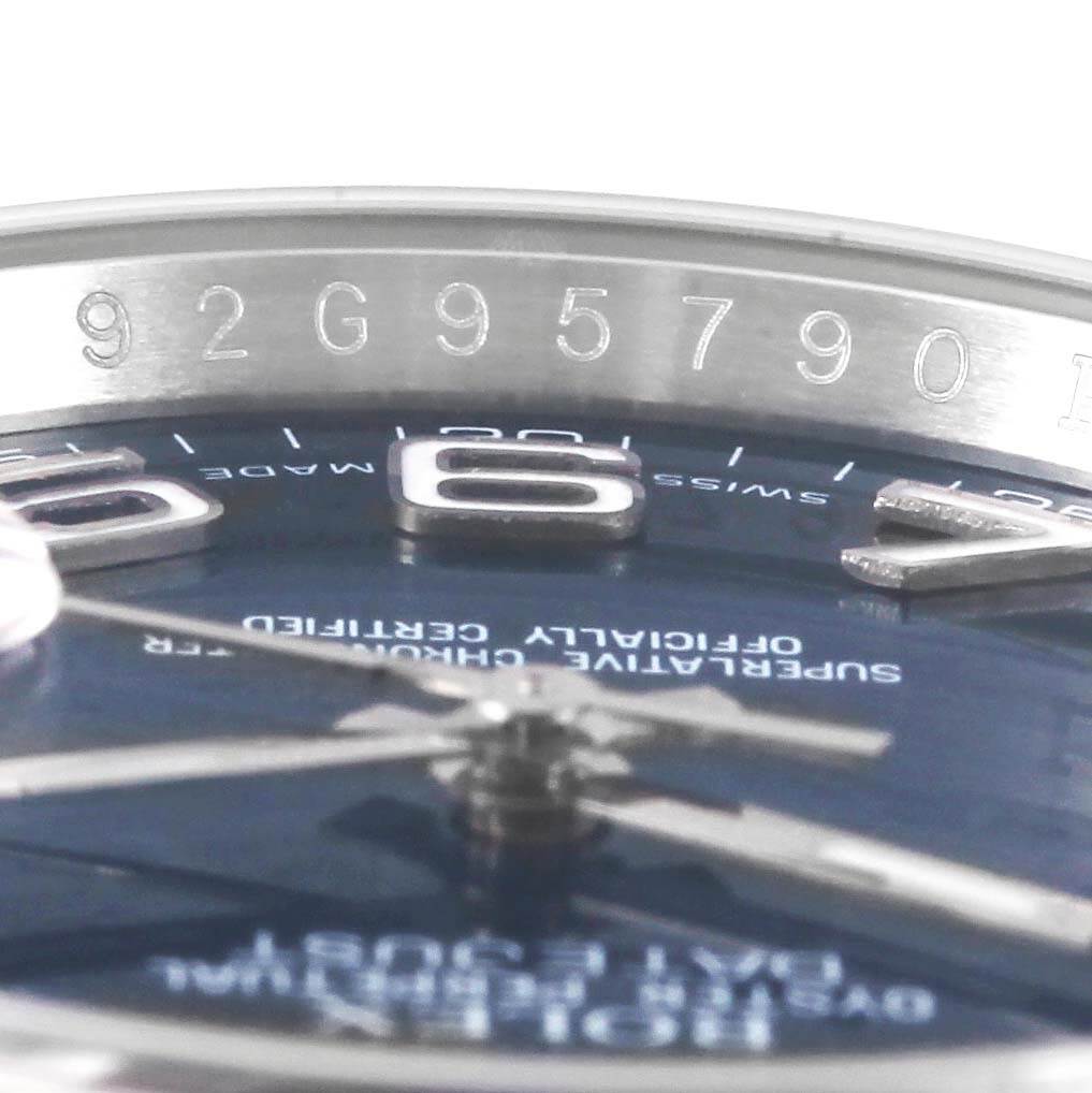This is a close-up angle of the Rolex Datejust 116234 Men
s Stainless Steel Blue Dial 116234 Men
s Stainless Steel Blue Dial watch, showcasing the bezel, partial dial, and serial number engraving.