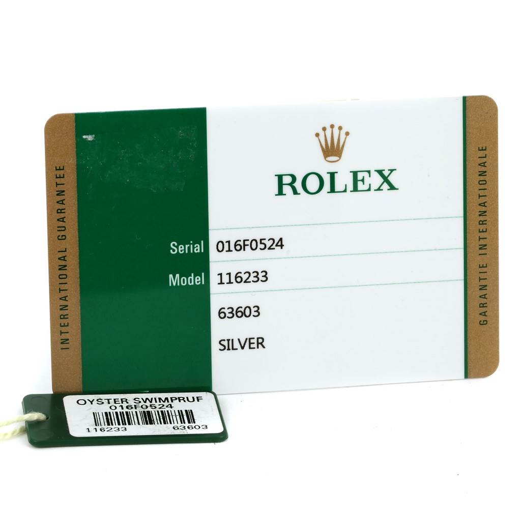 This image shows the warranty card and tag with serial and model numbers for a Rolex Datejust 116233 Men's Stainless Steel Silver Dial 116233 Men's Stainless Steel Silver Dial 116233 watch.