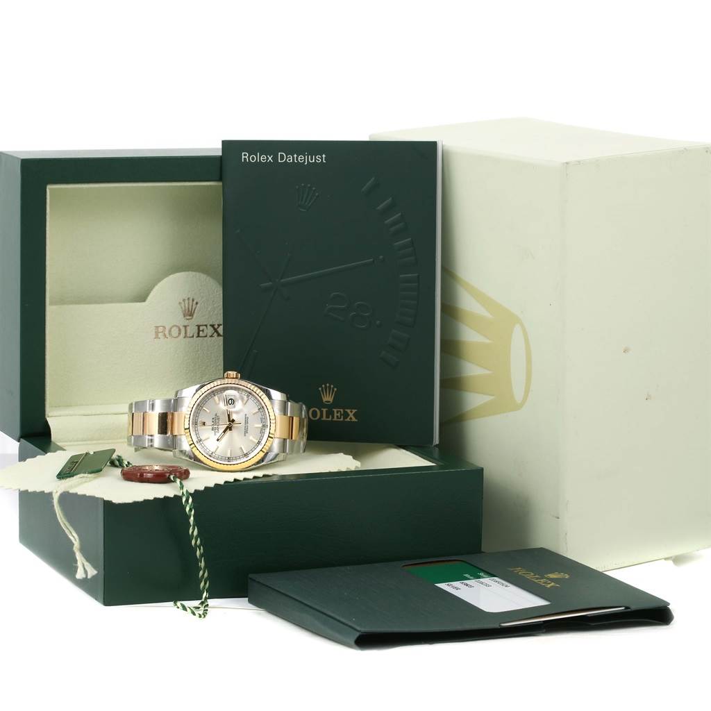 The Rolex Datejust 116233 Men's Stainless Steel Silver Dial 116233 Men's Stainless Steel Silver Dial watch is shown at an angle with its box, warranty card holder, and booklet.