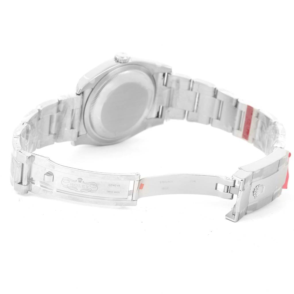 The image shows the backside of a Rolex Datejust 116234 Men's Stainless Steel Black Dial 116234 Men's Stainless Steel Black Dial watch, focusing on the open clasp and metal bracelet.