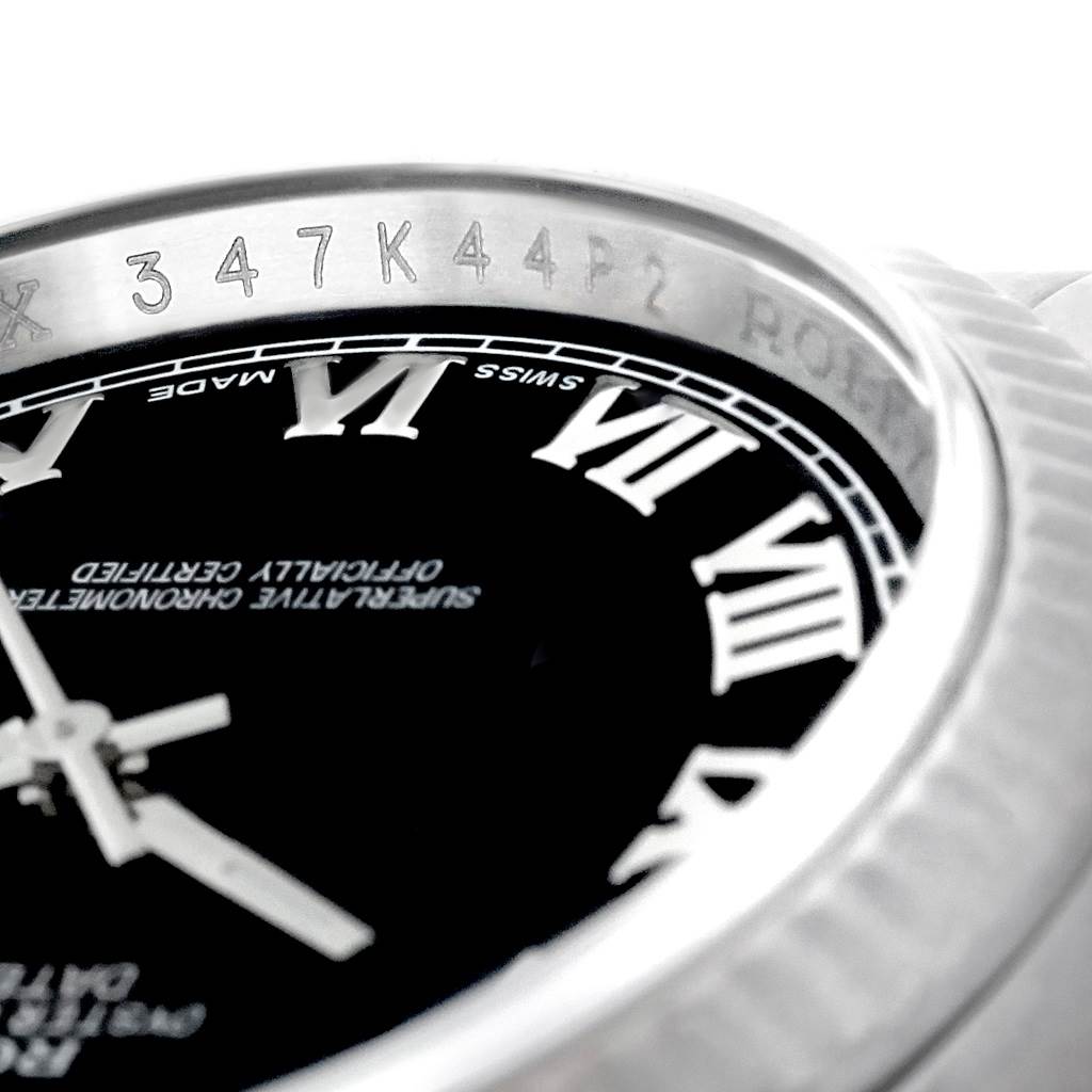 The image shows a close-up of the Rolex Datejust 116234 Men's Stainless Steel Black Dial 116234 Men's Stainless Steel Black Dial watch, highlighting the Roman numerals, part of the dial, and serial numbers.