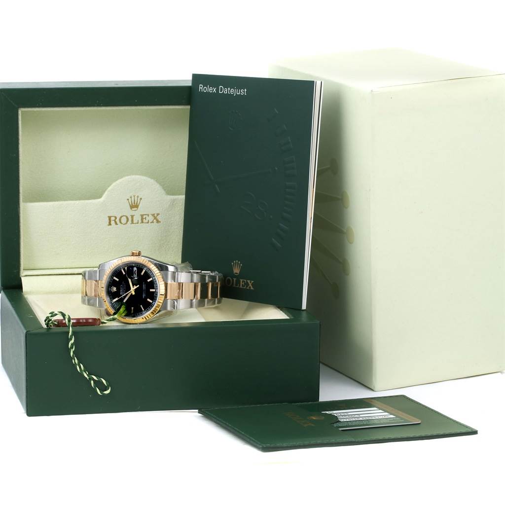 The image shows a Rolex Datejust 116233 Men
s Stainless Steel Black Dial 116233 Men
s Stainless Steel Black Dial watch at a straight-on angle, sitting inside its box with accompanying booklets and tags.