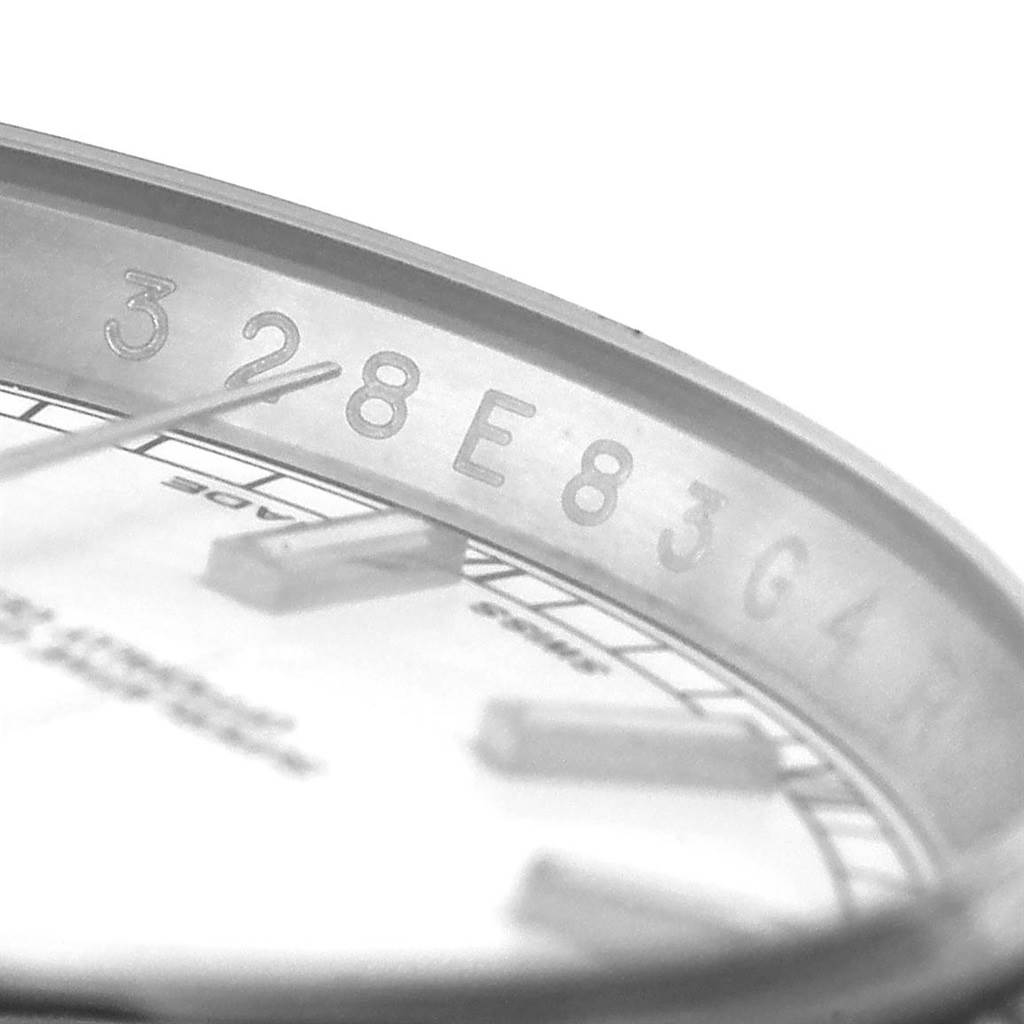 This image shows a close-up view of the inner bezel and dial of the Rolex Datejust 116234 Men
s Stainless Steel White Dial 116234 Men
s Stainless Steel White Dial watch, highlighting its serial number engraving.