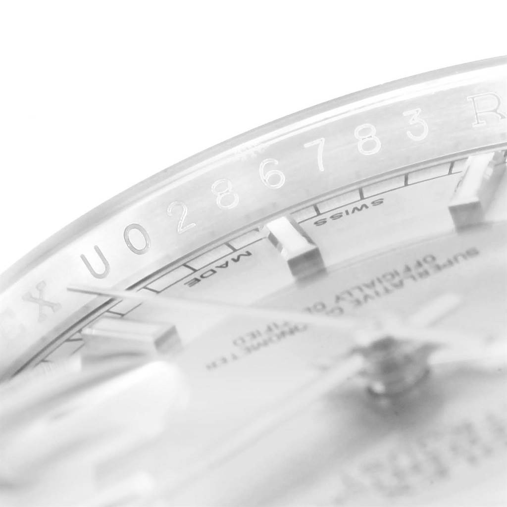The image shows a close-up angle of a Rolex Datejust 116234 Men
s Stainless Steel Silver Dial 116234 Men
s Stainless Steel Silver Dial watch, highlighting the serial number on the inner bezel.