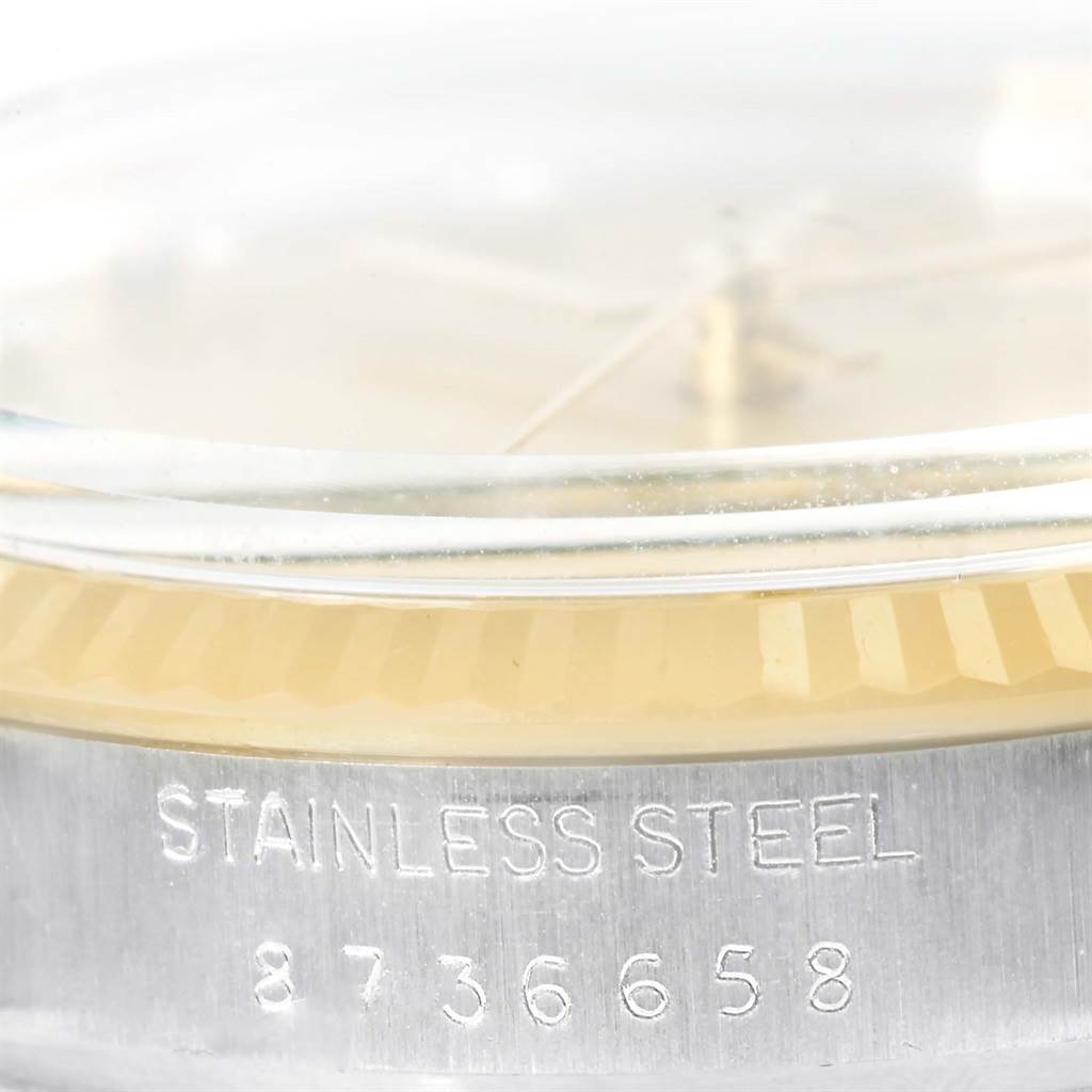 This close-up image shows the side and part of the bezel of the Rolex Datejust 16013 Men
s Stainless Steel Champagne Dial 16013 Men
s Stainless Steel Champagne Dial, highlighting the "STAINLESS STEEL" engraving and serial number.