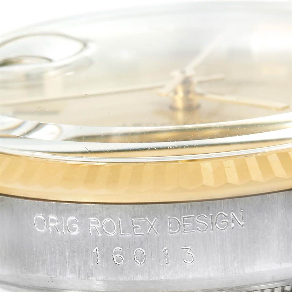 This close-up angle of the Rolex Datejust 16013 Men
s Stainless Steel Champagne Dial 16013 Men
s Stainless Steel Champagne Dial watch shows the side of the case with "ORIG ROLEX DESIGN 16013" engraved.