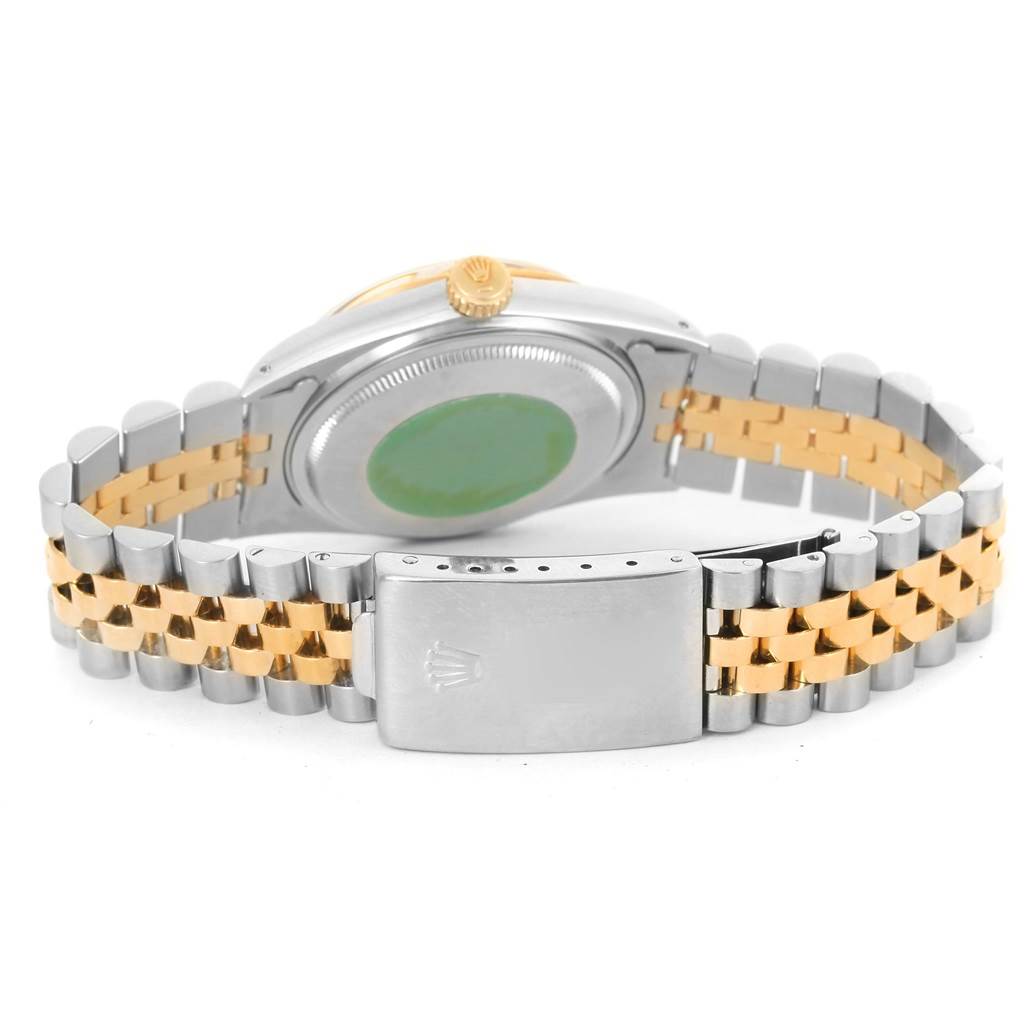 The image shows the back of a Rolex Datejust 16013 Men
s Stainless Steel Champagne Dial 16013 Men
s Stainless Steel Champagne Dial watch, focusing on the case back, crown, and two-tone bracelet with the clasp.