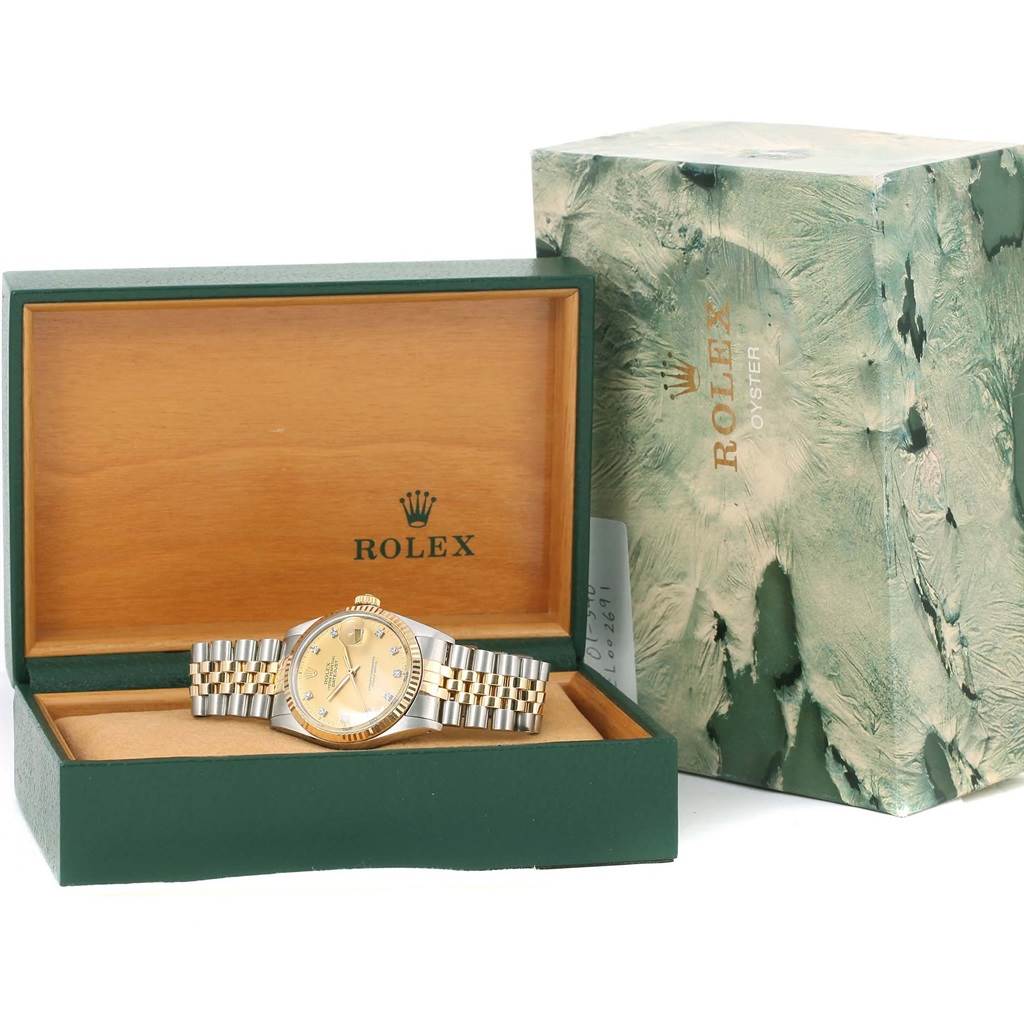 The Rolex Datejust 16013 Men
s Stainless Steel Champagne Dial 16013 Men
s Stainless Steel Champagne Dial watch is shown in its open box with an outer packaging box beside it.