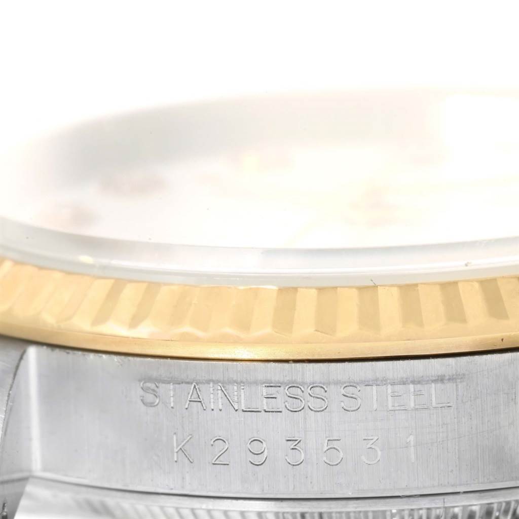 This close-up image shows the stainless steel case, the model number, and part of the gold bezel of the Rolex Datejust 16233 Men's Steel and Gold (two tone) Champagne Dial 16233 Men's Steel and Gold (two tone) Champagne Dial.