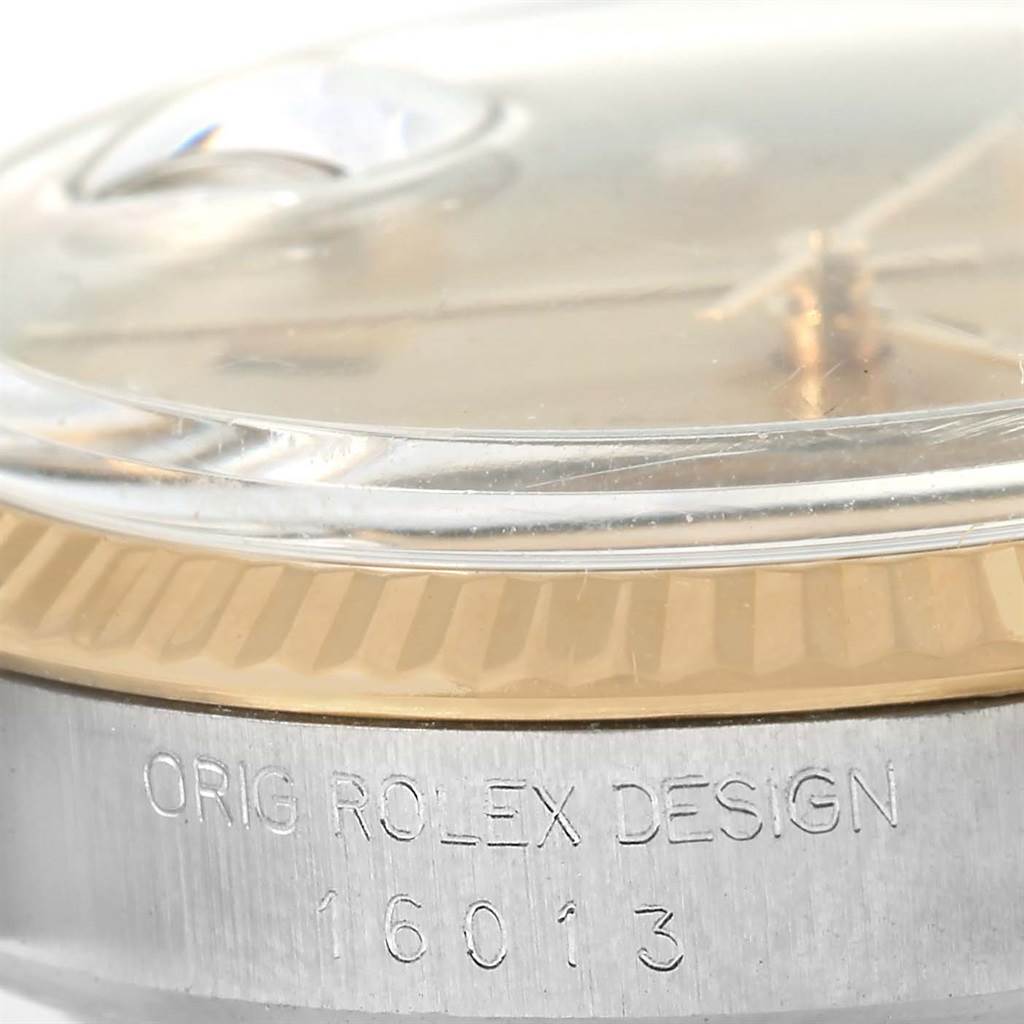 The image shows a close-up angle of the bezel, crystal, and part of the case with the model number of a Rolex Datejust 16013 Stainless Steel Champagne Dial 16013 Stainless Steel Champagne Dial.