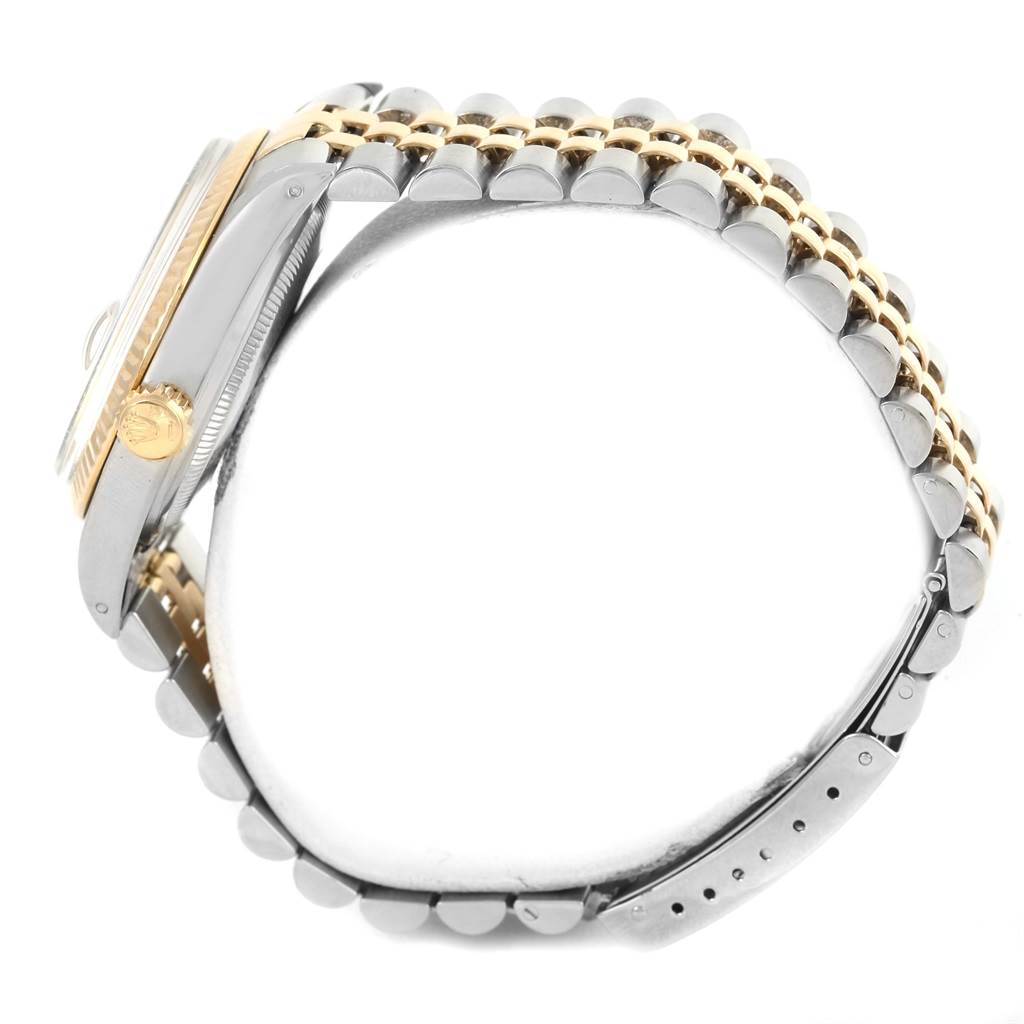 The image shows a side view of the Rolex Datejust 16013 Stainless Steel Champagne Dial 16013 Stainless Steel Champagne Dial watch, highlighting the crown, case, and two-tone bracelet.