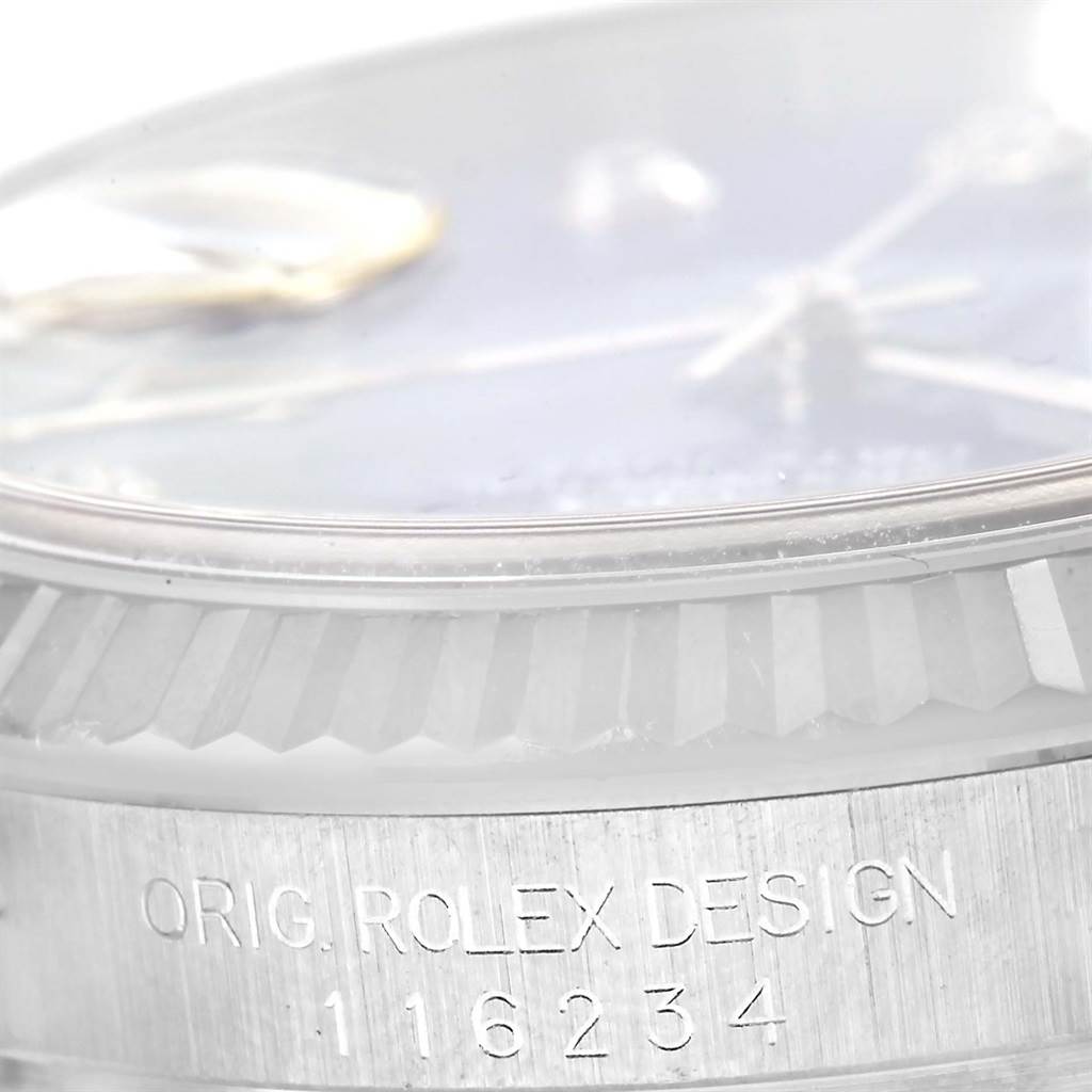 The image shows a close-up of the top edge and part of the fluted bezel of a Rolex Datejust 116234 Men's Stainless Steel Blue Dial 116234 Men's Stainless Steel Blue Dial watch, along with the model number 116234.