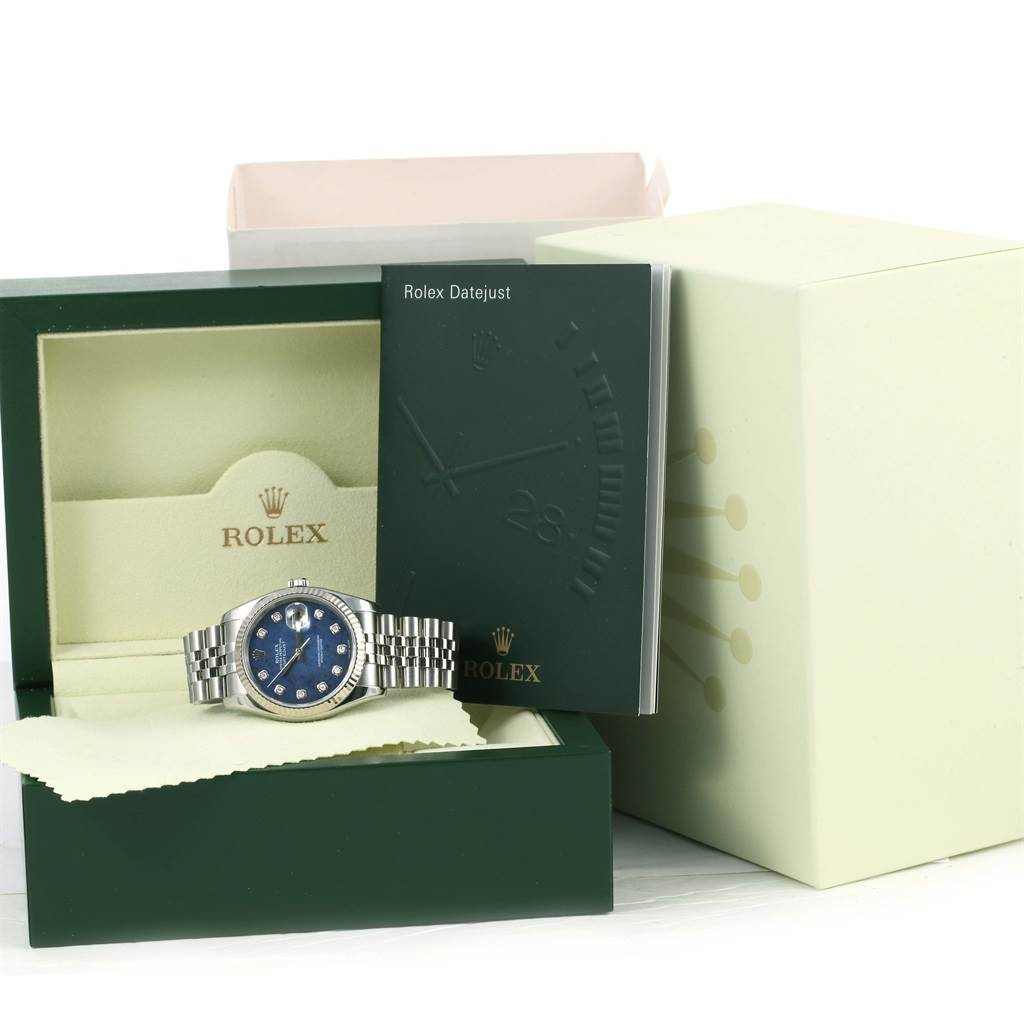 The image shows a Rolex Datejust 116234 Men's Stainless Steel Blue Dial 116234 Men's Stainless Steel Blue Dial watch with a blue dial, presented in its box along with an instructional booklet and accessories.