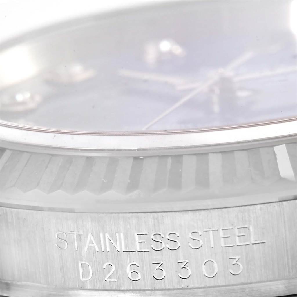 This image shows a close-up of the bezel and case side of a Rolex Datejust 116234 Men's Stainless Steel Blue Dial 116234 Men's Stainless Steel Blue Dial, highlighting the serial number engraved on the stainless steel.