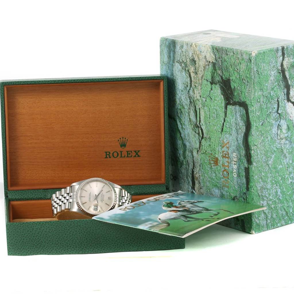 The image shows the Rolex Datejust 16234 Men's Stainless Steel Silver Dial 16234 Men's Stainless Steel Silver Dial watch with its open wooden box, outer green box, and a booklet at an angle showcasing all items.