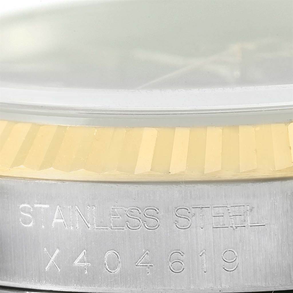 The image shows a close-up of the stainless steel casing and fluted bezel of a Rolex Datejust 16233 Men's Steel and Gold (two tone) Black Dial 16233 Men's Steel and Gold (two tone) Black Dial watch.
