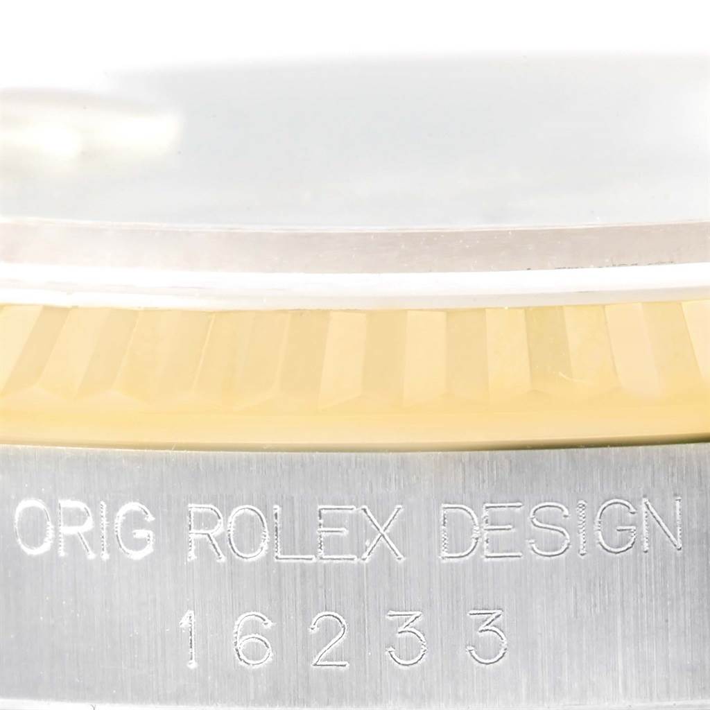 This close-up image shows the engraved bezel and case side of the Rolex Datejust 16233 Men's Steel and Gold (two tone) Beige Dial 16233 Men's Steel and Gold (two tone) Beige Dial model.