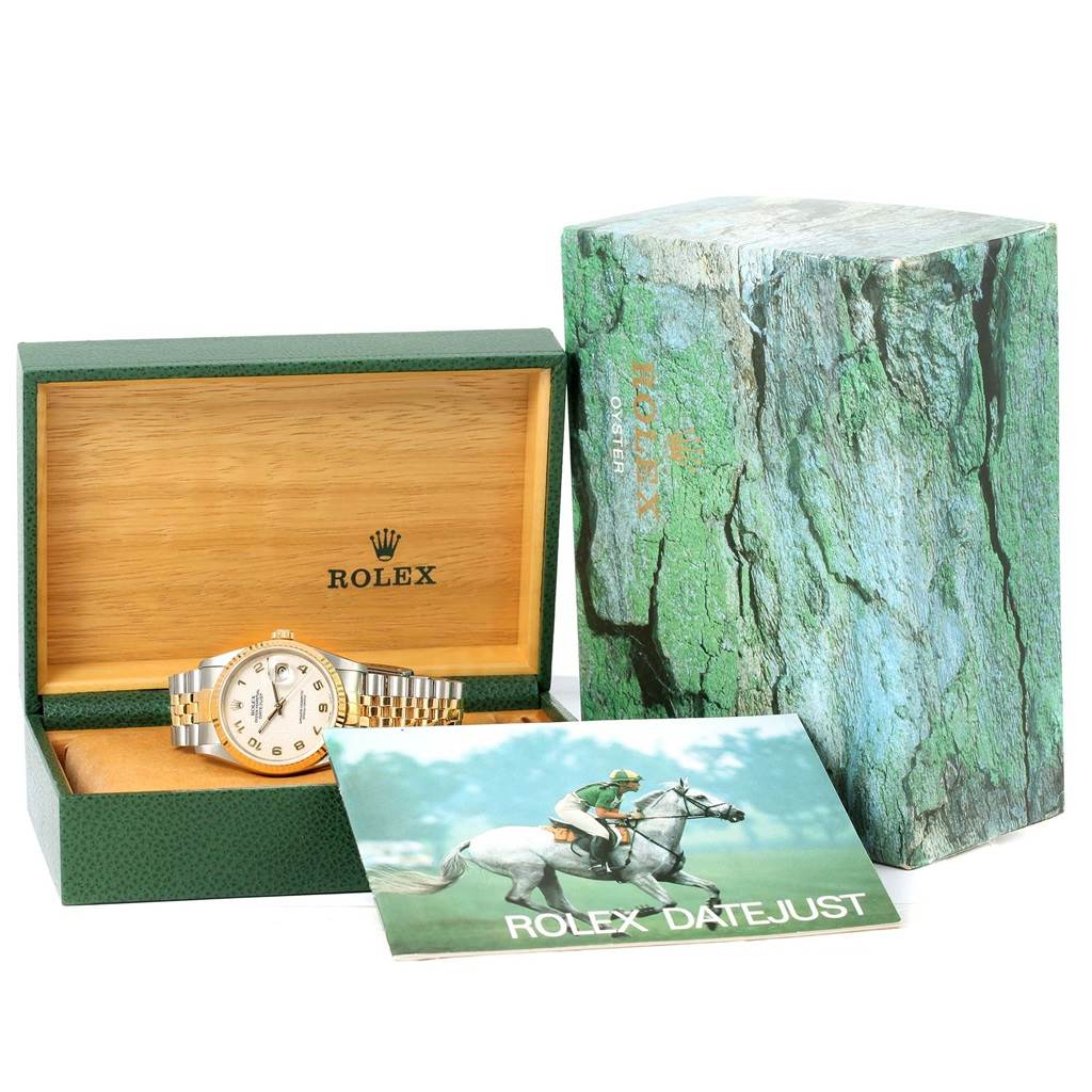 The image shows a Rolex Datejust 16233 Men's Steel and Gold (two tone) Beige Dial 16233 Men's Steel and Gold (two tone) Beige Dial watch in a green and wooden box with its outer packaging and booklet.