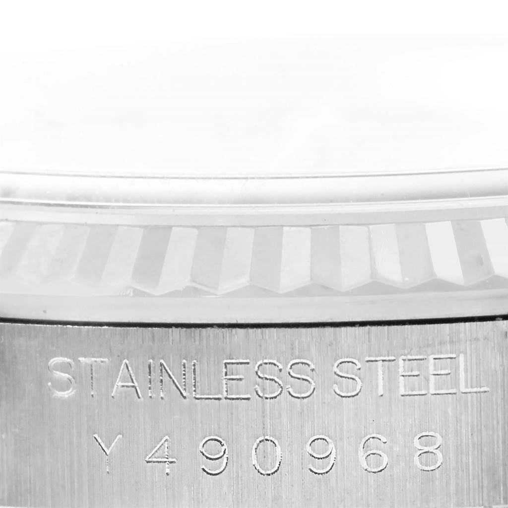 Close-up of the bezel and engraved serial number on a Rolex Datejust 16234 Men's Stainless Steel Blue Dial 16234 Men's Stainless Steel Blue Dial watch, displaying "STAINLESS STEEL" and the serial "Y490968".