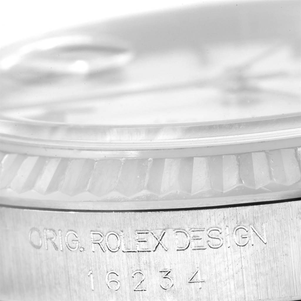 This image shows a close-up of the fluted bezel and case edge of the Rolex Datejust 16234 Men
s Stainless Steel White Dial 16234 Men
s Stainless Steel White Dial, featuring its model number and "ORIG. ROLEX DESIGN" engraving.