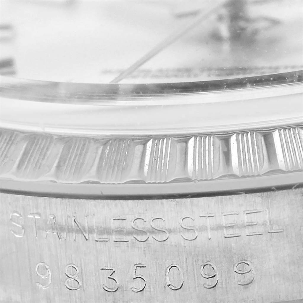 Close-up of the Rolex Datejust 16030 Men's Stainless Steel Silver Dial 16030 Men's Stainless Steel Silver Dial’s stainless steel bezel and serial number engraving.