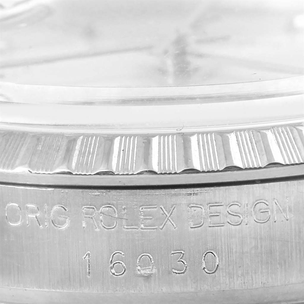 This image shows a close-up of the side of a Rolex Datejust 16030 Men's Stainless Steel Silver Dial 16030 Men's Stainless Steel Silver Dial watch with focus on the bezel and inscription on the case.