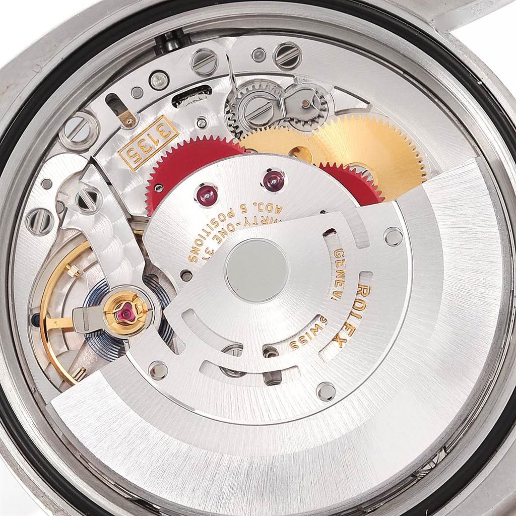 The image shows the internal mechanics of a Rolex Datejust 116200 Men
s Stainless Steel Silver Dial 116200 Men
s Stainless Steel Silver Dial watch, focusing on its movement and intricate gears.