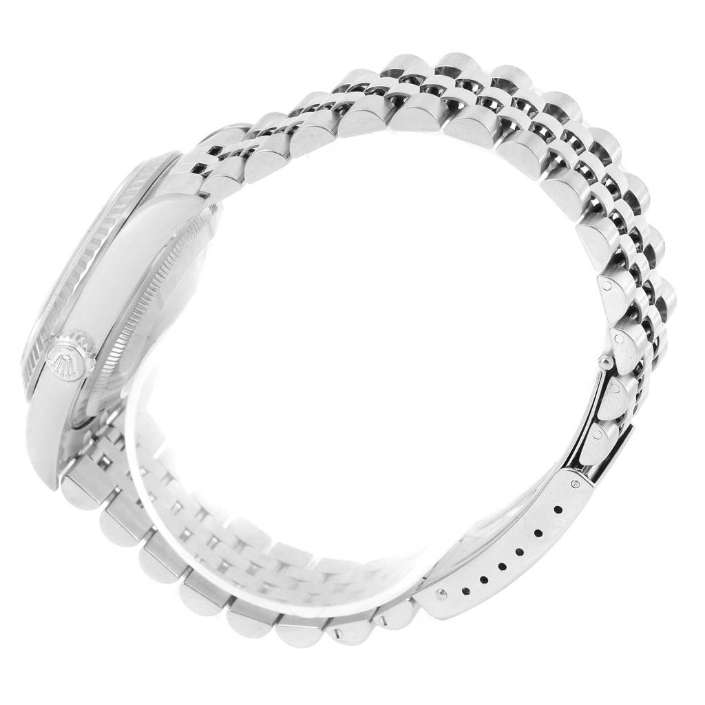 The image shows a side view of a Rolex Datejust 16234 Men's Stainless Steel Silver Dial 16234 Men's Stainless Steel Silver Dial watch focusing on its bezel, crown, and jubilee bracelet.