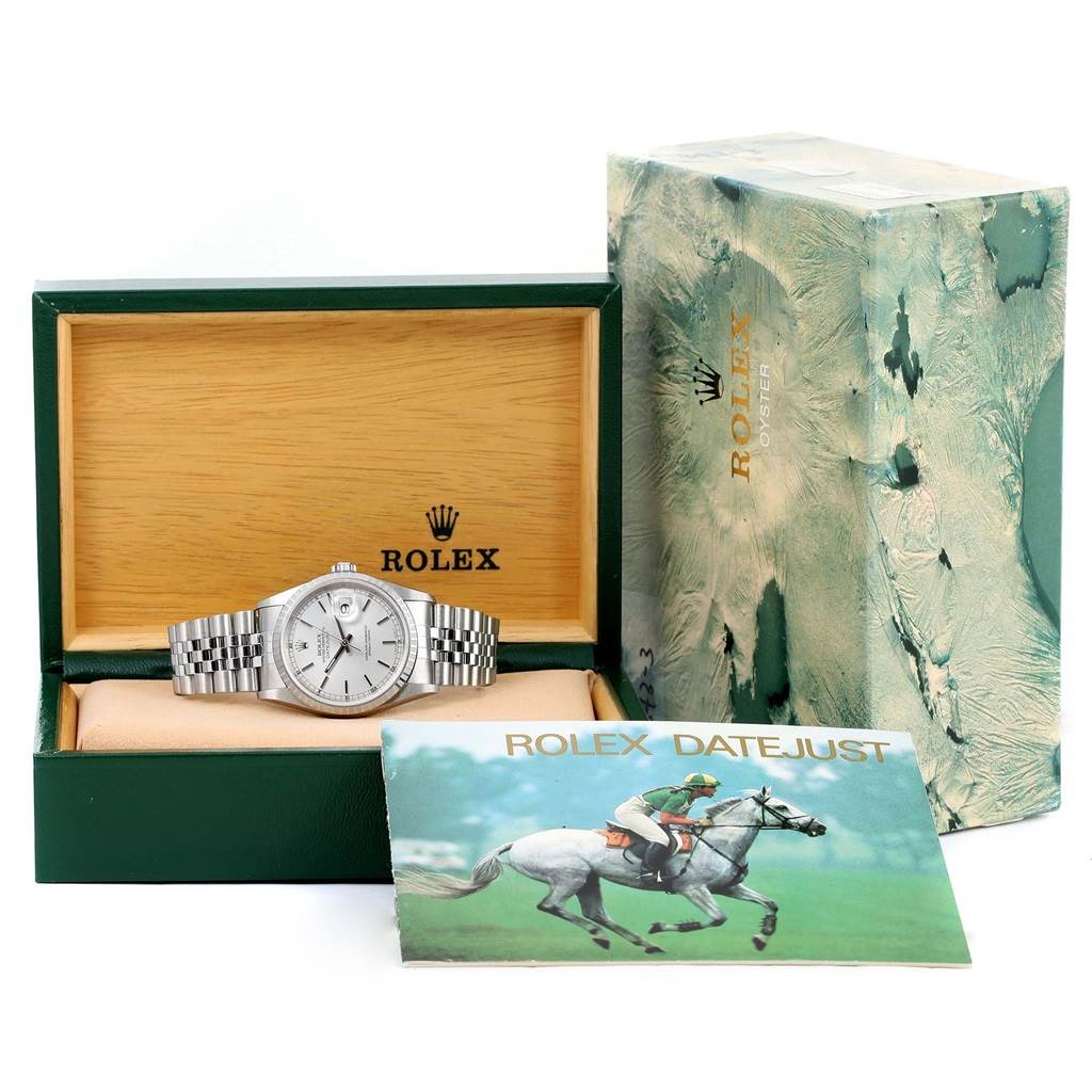 The Rolex Datejust 16220 Men's Stainless Steel Silver Dial 16220 Men's Stainless Steel Silver Dial watch is displayed in its box, accompanied by outer packaging and a booklet.
